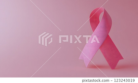 Prominent pink ribbon on a minimalist background representing the commitment to breast cancer awareness. Awareness concept 123243019