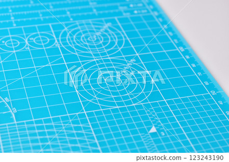 blue cutting mat board on white background with line and scale measure guide pattern for art design 123243190