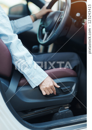 Business woman hand adjust car seat before drive on the road. Ergonomic, health  care and safety transportation concept 123243415