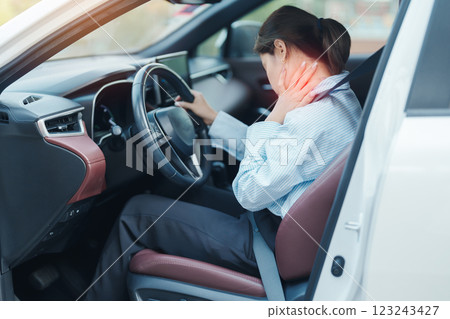 woman with her shoulder and neck sprain while driving car long time, muscle painful. Shoulder ache, Scapular pain, office syndrome and ergonomic concept 123243427