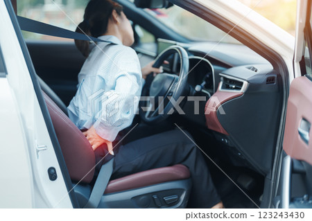 woman with her back sprain while driving car long time, back body ache due to Piriformis Syndrome, Low Back Pain and Spinal Compression. Ergonomic and medical concept 123243430