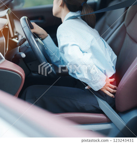 woman with her back sprain while driving car long time, back body ache due to Piriformis Syndrome, Low Back Pain and Spinal Compression. Ergonomic and medical concept 123243431