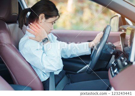 woman with her shoulder and neck sprain while driving car long time, muscle painful. Shoulder ache, Scapular pain, office syndrome and ergonomic concept woman with her shoulder and neck sprain while driving car long time, muscle painful. Shoulder ache, Scapular pain, office syndrome and ergonomic concept 123243441