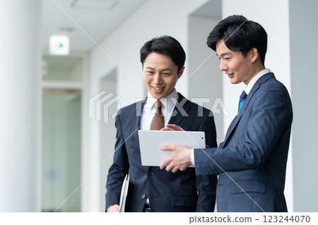 A businessman talking with a tablet. Filming cooperation: SKY Perfect Tokyo Media Center 123244070
