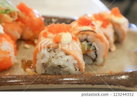 salmon rolls or maki or rice topped with fish or Japanese rolls 123244352