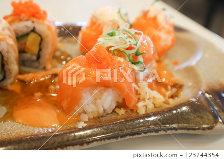 salmon rolls or maki or rice topped with fish or Japanese rolls salmon rolls or maki or rice topped with fish or Japanese rolls 123244354