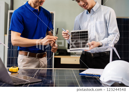 Construction team, blueprint and site building job for architect, builder and engineer sketching a construction project, green energy and solar panel concept 123244548