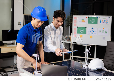 Construction team, blueprint and site building job for architect, builder and engineer sketching a construction project, green energy and solar panel concept 123244549