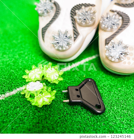 Golf shoes, spikes and a spike wrench [Golf equipment image] 123245146