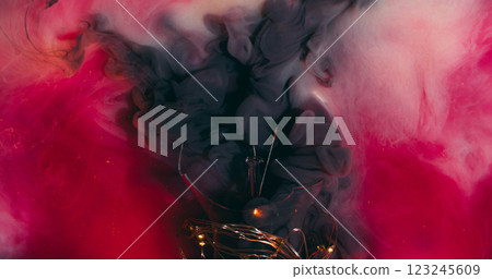 Ink swirling. Smoke explosion. Magic mixing pink black grey foggy liquid paint small particles background texture with broken glass light equipment. Ink swirling. Smoke explosion. Magic mixing pink black grey foggy liquid paint small particles background texture with broken glass light equipment. 123245609
