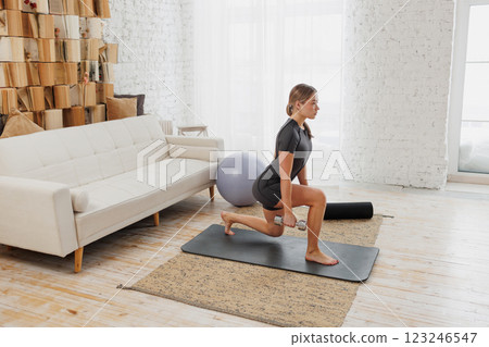 Slender girl in sportswear doing physical exercises. healthy lifestyle. 123246547