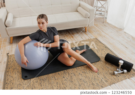 young girl doing home fitness, home workouts 123246550