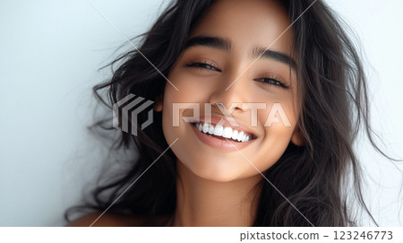 Radiant smile of a beautiful woman with shiny brunette hair. The glow around her is simply irresistible and so appealing to the senses. Radiant smile of a beautiful woman with shiny brunette hair. The glow around her is simply irresistible and so appealing to the senses. 123246773