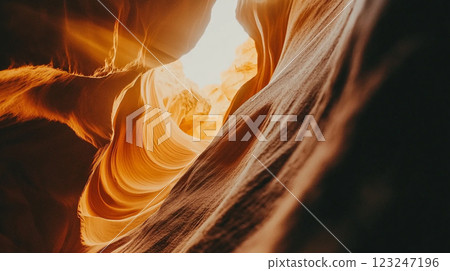 Sunlit canyon with winding sandstone formations. Dramatic lighting and textures create a unique and captivating desert landscape. Sunlit canyon with winding sandstone formations. Dramatic lighting and textures create a unique and captivating desert landscape. 123247196