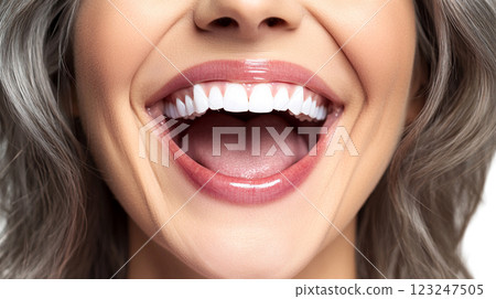Close-up of a woman's radiant smile with bright white teeth. Glossy lips and soft gray hair frame her face, capturing a moment of happiness. 123247505