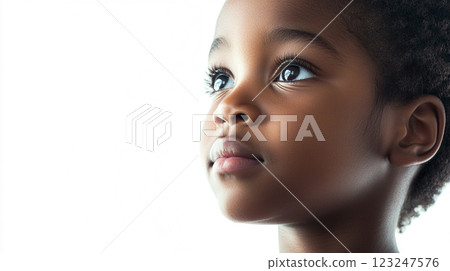 Young girl looking upward with bright eyes and a thoughtful expression. She gazes into the distance, with a bright white background. Young girl looking upward with bright eyes and a thoughtful expression. She gazes into the distance, with a bright white background. 123247576