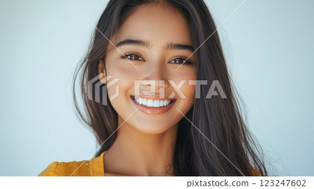 Smiling Woman: Radiant beauty, confident smile, luminous skin, and healthy hair in a bright portrait against a clean backdrop. 123247602