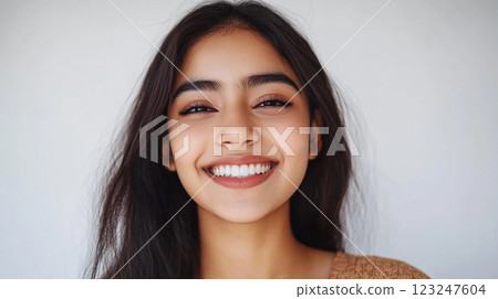 Radiant Portrait: Capturing the essence of youthful joy through a genuine smile and bright eyes, embodying natural beauty and confidence. 123247604