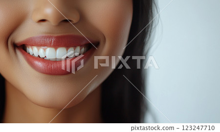 Radiant smile showcasing healthy white teeth complemented by a dark lipstick shade. A picture of dental hygiene and beauty expression. 123247710