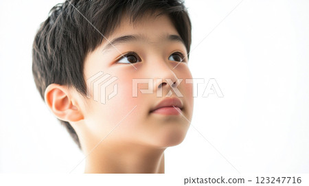 Portrait of a young boy with a hopeful expression, gazing upwards. His skin has a soft, delicate quality with a clean, bright background. Portrait of a young boy with a hopeful expression, gazing upwards. His skin has a soft, delicate quality with a clean, bright background. 123247716