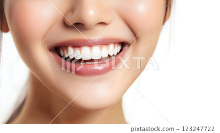 A close-up shot of a woman's radiant smile highlighting clean and straight teeth. Skin is soft with pinkish lips. Dental health concept. A close-up shot of a woman's radiant smile highlighting clean and straight teeth. Skin is soft with pinkish lips. Dental health concept. 123247722