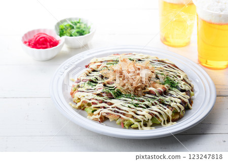 Okonomiyaki (squid and egg) served on a white plate 123247818