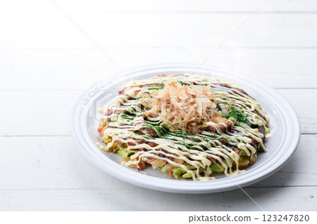 Okonomiyaki (squid and egg) served on a white plate 123247820