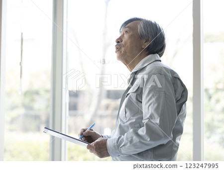 Senior man in work clothes inspecting Senior man in work clothes inspecting 123247995