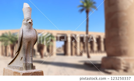Horizontal banner with granite statue of falcon God Horus, palm and ancient columns, Karnak Temple Complex, Luxor (ancient Thebes), Egypt, North Africa Horizontal banner with granite statue of falcon God Horus, palm and ancient columns, Karnak Temple Complex, Luxor (ancient Thebes), Egypt, North Africa 123250337
