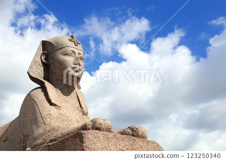 Famous Sphinx in Serapeum of Alexandria, Egypt, North Africa. Roman temple Serapeum with Pompey's pillar and sphinx. On blue sky and white clouds background Famous Sphinx in Serapeum of Alexandria, Egypt, North Africa. Roman temple Serapeum with Pompey's pillar and sphinx. On blue sky and white clouds background 123250340