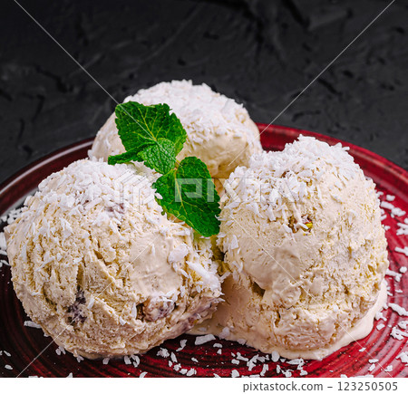 Delicious coconut ice cream served with fresh mint leaves Delicious coconut ice cream served with fresh mint leaves 123250505