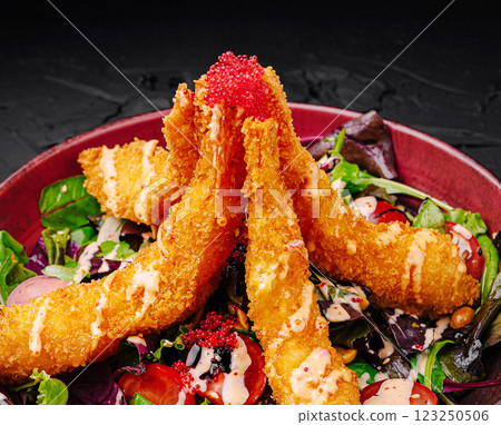Crispy shrimp and fresh salad served in vibrant bowl Crispy shrimp and fresh salad served in vibrant bowl 123250506