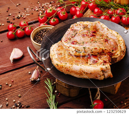 Juicy marinated meat resting on a rustic wooden table Juicy marinated meat resting on a rustic wooden table 123250629