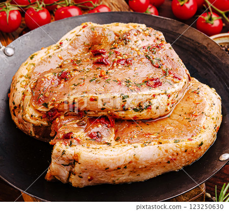 Marinated pork chops prepared for grilling at a summer barbecue 123250630