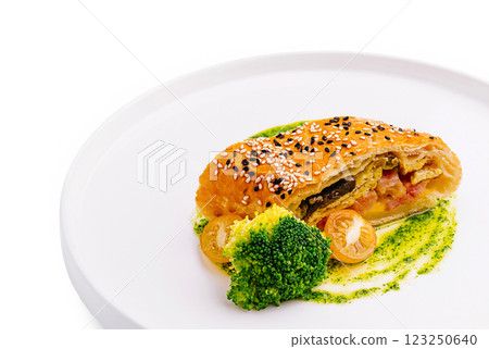 Delicious pastry filled with vegetables and served with sauce Delicious pastry filled with vegetables and served with sauce 123250640