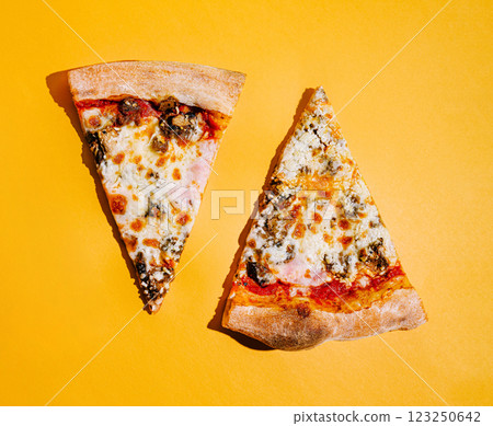 Delicious pizza slices on a vibrant yellow background 123250642