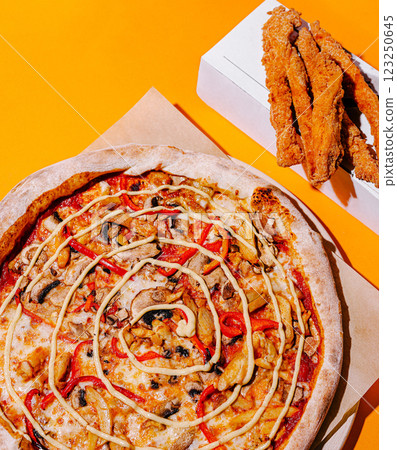 Delicious pizza with unique toppings served alongside crispy fries Delicious pizza with unique toppings served alongside crispy fries 123250645