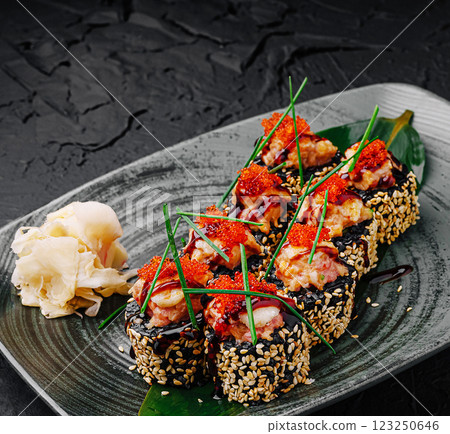 Delicious sushi rolls adorned with vibrant toppings on a plate Delicious sushi rolls adorned with vibrant toppings on a plate 123250646