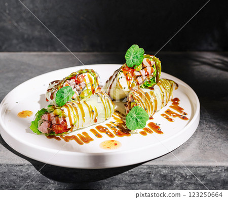 Delicious lettuce wraps with savory filling on a sleek plate Delicious lettuce wraps with savory filling on a sleek plate 123250664