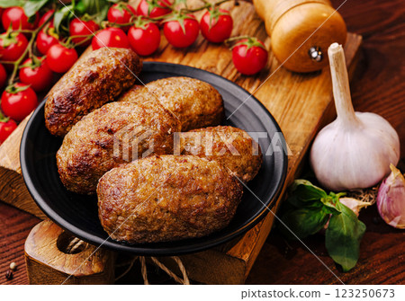 Deliciously grilled meatballs served with fresh tomatoes and garlic 123250673