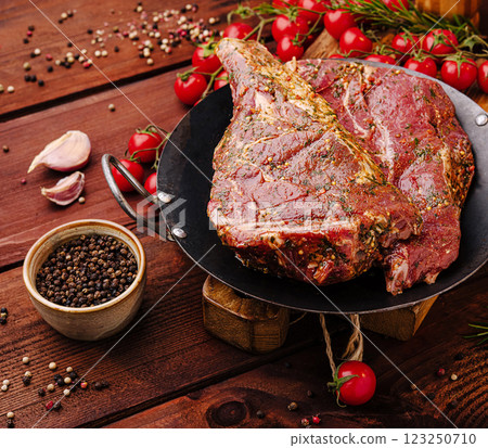 Freshly marinated meat with garlic and tomatoes on wooden table 123250710