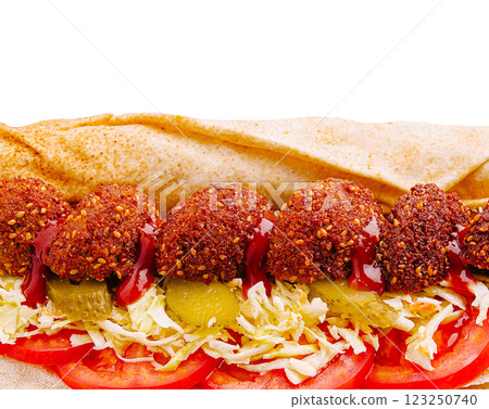Delicious falafel wrap loaded with fresh toppings and sauces 123250740