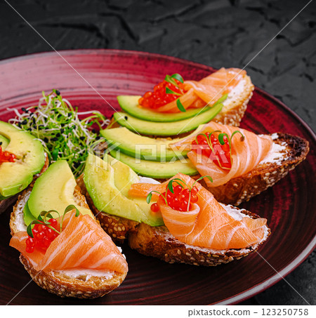 Delicious open-faced sandwiches featuring salmon and avocado Delicious open-faced sandwiches featuring salmon and avocado 123250758