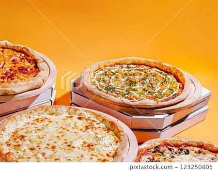 Delicious pizzas with varied toppings against a bright background 123250805