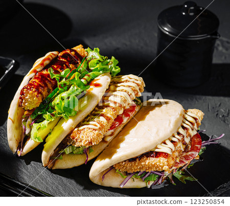 Delicious stuffed buns filled with fresh ingredients and sauces 123250854