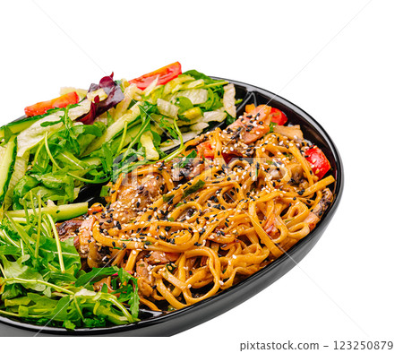 Delicious vegetable and noodle dish served in a black bowl Delicious vegetable and noodle dish served in a black bowl 123250879