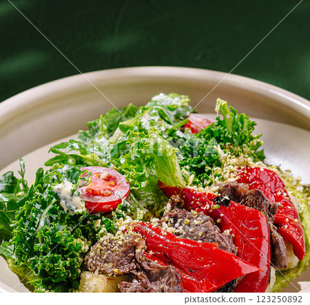 Colorful salad with beef and vegetables served in a bowl 123250892