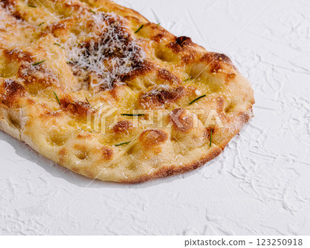 Freshly baked cheesy flatbread on white background 123250918
