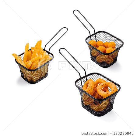 Three serving baskets with various fried snacks on a table Three serving baskets with various fried snacks on a table 123250943