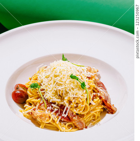 Delicious spaghetti with cheese and tomatoes on a white plate Delicious spaghetti with cheese and tomatoes on a white plate 123250967